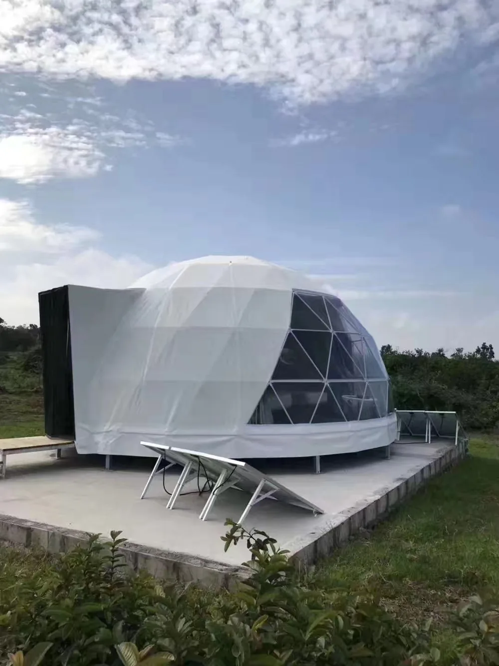 Dome op een betonnen vloerplaat met ligbedden ervoor
