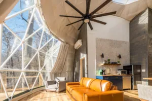 Ruim domeinterieur met plafondventilator, zithoek en keukenblok